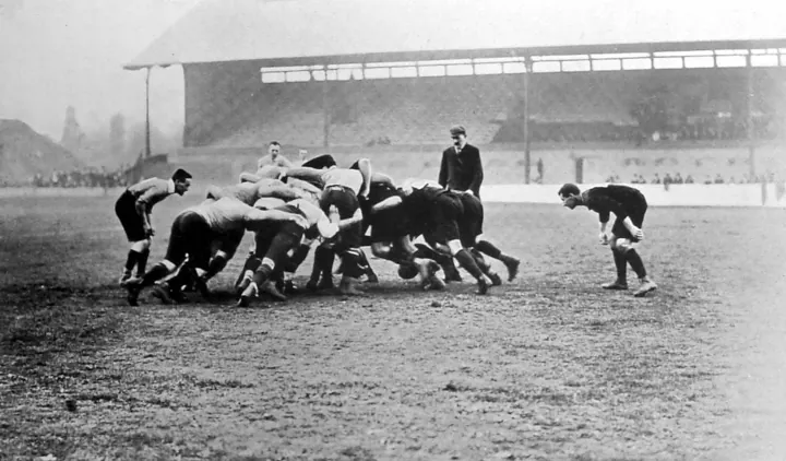 Photo d’origine : Une mêlée de rugby sur un terrain brumeux, vue d'ensemble